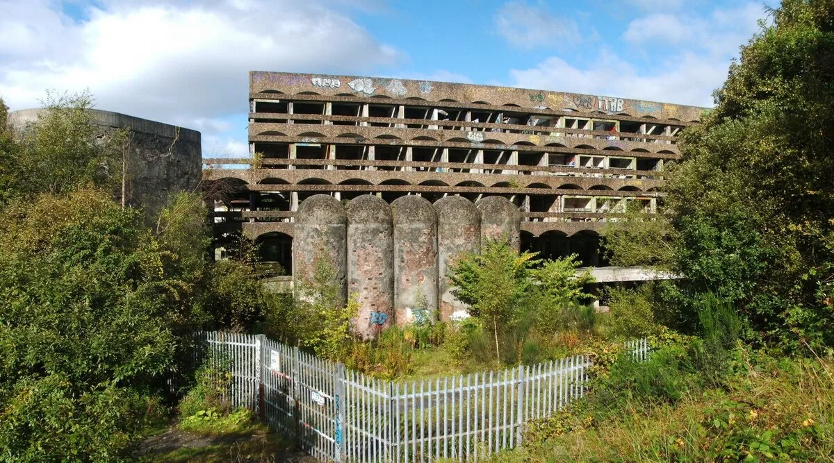 The roofless concrete shell of St Peter's Seminary at Cardross, overgrown and graffitied