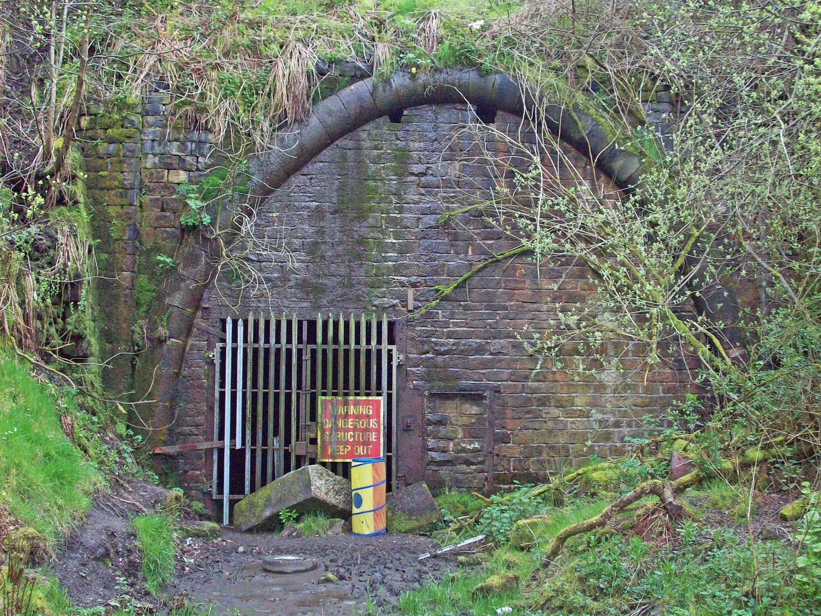 The gated stone portal of the disused Queensbury railway tunnel near Bradford in West Yorkshire