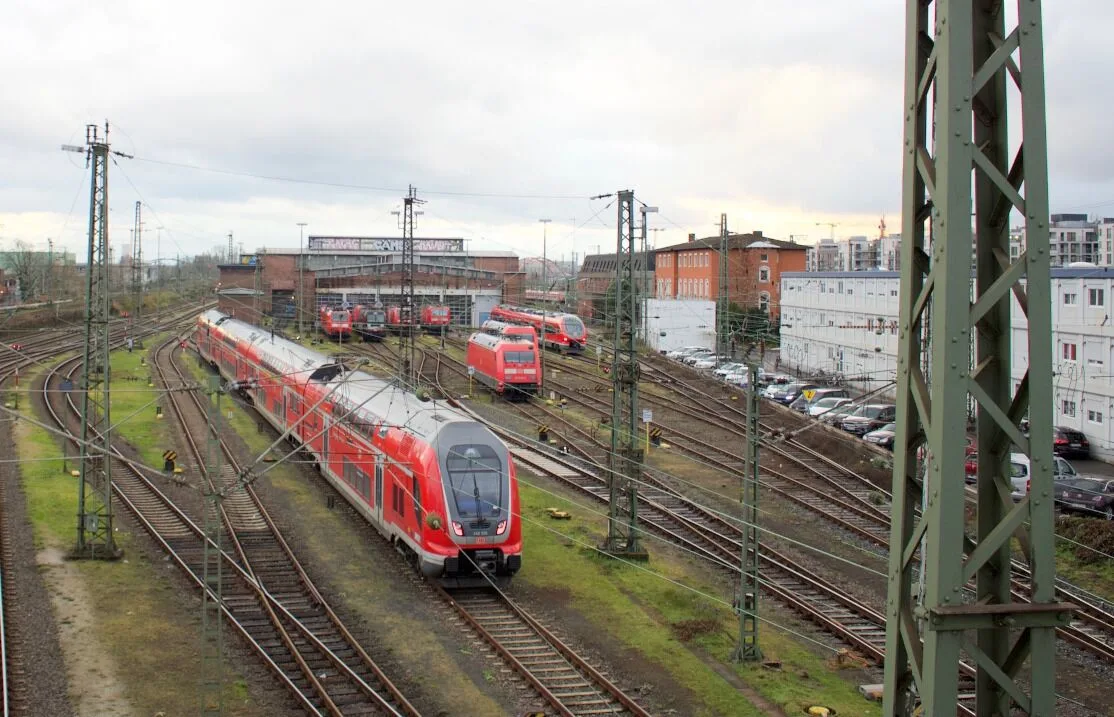The abandoned Locomotive Depot 1 (Bahnbetriebswerk 1) in the track field west of Frankfurt main station: the long graffiti-covered engine shed with parked locomotives, seen from the Camberger Brücke