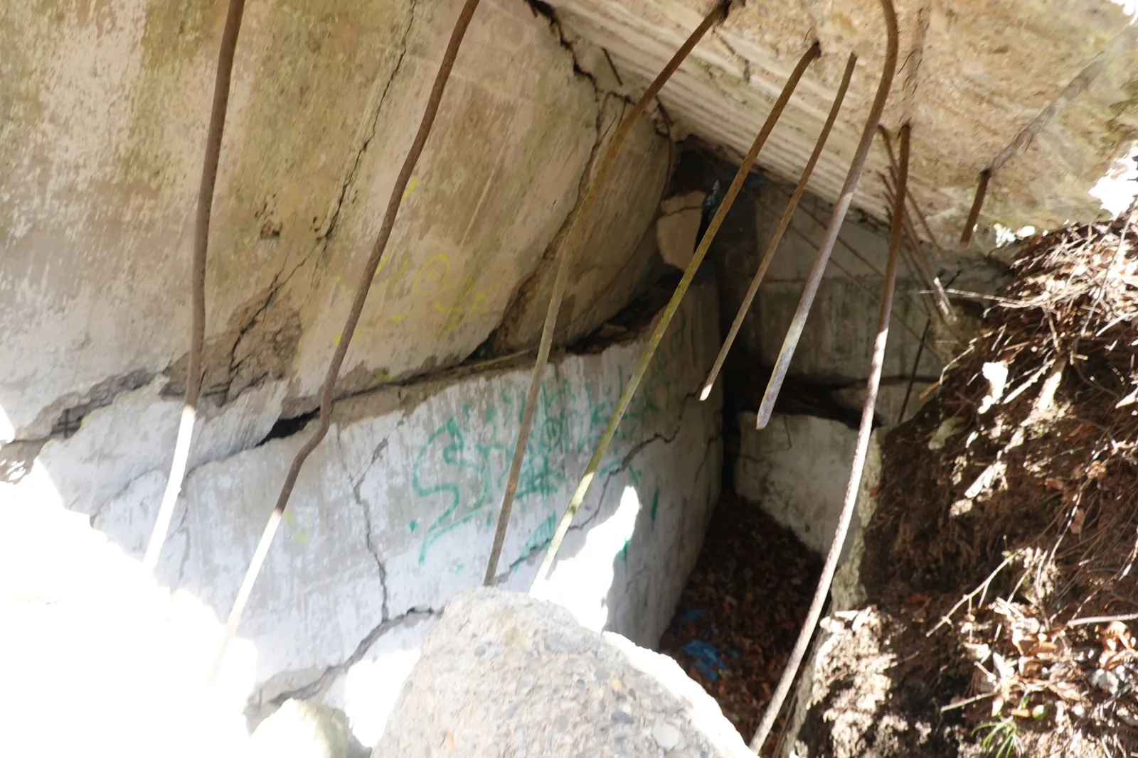 Blown-up explosives bunker of the Deutsche Sprengchemie in the forest near Geretsried, with cracked concrete and exposed reinforcing steel